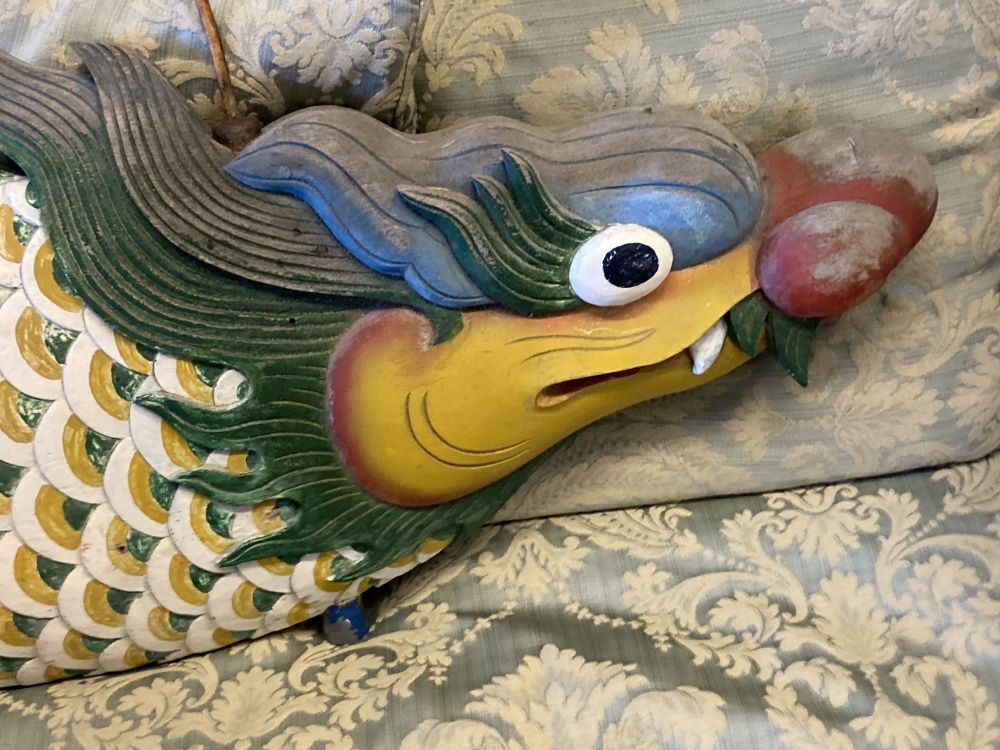 A Balinese carved painted wood and metal weather vane, length 138cm together with a painted Balinese rail